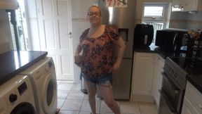 MILF stripping in shorts in the kitchen
