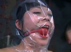 Wicked mistress puts a plastic bag over her slave's head