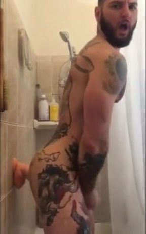 Tatted Hunk Fucks Dildo in Shower Until He Cums