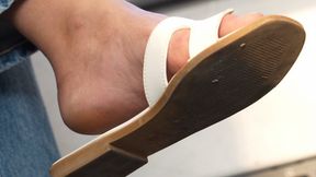 Foot and shoe fetish admiration, dirty feet and slippers dangling close-up, hot feet.