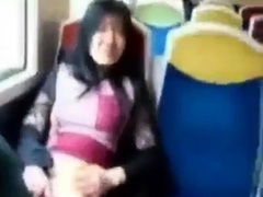 Asian milf rubs her clit on a train.