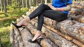 Black classic Stiletto High Heels with no back, 12 cm heels in the forest, deep in the sand