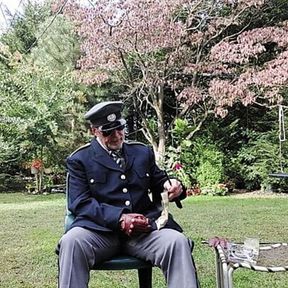 Military officer enjoys smoking his pipe and getting off