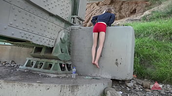 Strong girl in flip flops tries to move bridge and gets stuck