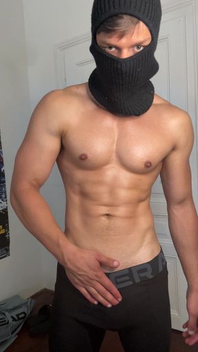 Masked hunk showing off his muscles