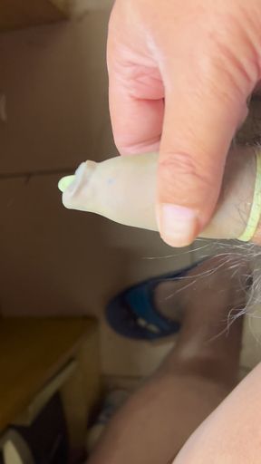 Cock wears a long, green transparent balloon