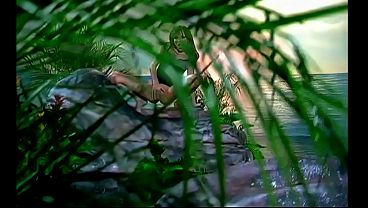 She pulls out a clear glass dildo with thick black ridges and begins to rub it against her...