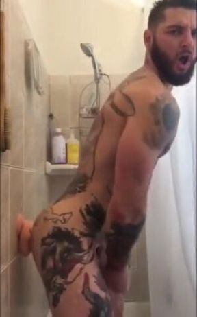 Tatted Hunk Fucks Dildo in Shower Until He Cums