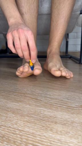 playing with a tiny lego figurine with my feet