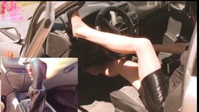 Revving in black barefoot and footjob to gearstick