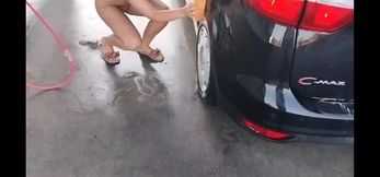 naked woman washes a car in public at a car wash