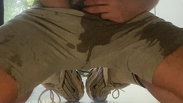 Amateur boy wets himself on the kitchen floor