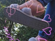 Dangling my house slippers on my toes.