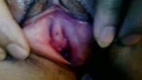 Trashy black hoe stretching her pussy lips with fingers