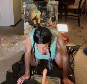 Dark-haired hottie with braided pony tails sucks large dildo.