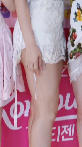 Slim Blonde GF with long legs stands in a K-pop group showing off