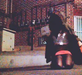 Hot slutty college girl shows her vib remote controller while many people passing by on public street, with vibrator on