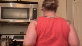 Milf cooks sausage with buttcrack out