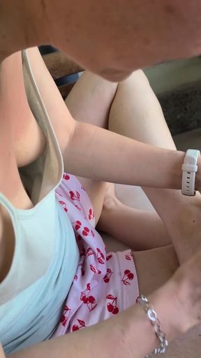 MILF shows off her tits in a downblouse while sitting alone