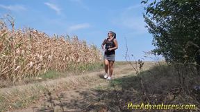 Pee standing on a dirt road in the countryside