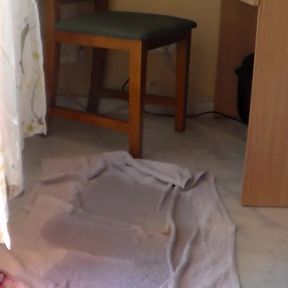 John is sitting on a chair and is peeing on the floor