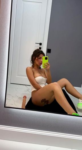 I'm sitting in front of the mirror, touching my pussy