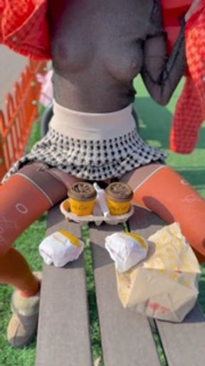 Naked drinking coffee in the park