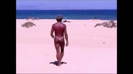 Tanned guy on beach in tiny string thong (temporarily!)