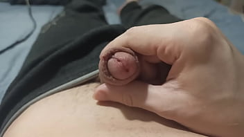 Gently and slowly opens and closes the head of his penis
