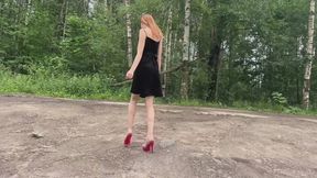 A girl in extremely high-heeled shoes kneads mud with her shoes (reissue)