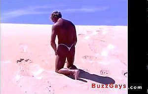Tanned guy on beach in tiny string thong (temporarily!)