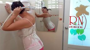 The girl bathes in a shower in a T-shirt and in shorts. Shower naked show