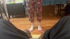 girl takes cares of mans feet after work. she takes off his boots and socks and smells them deeply