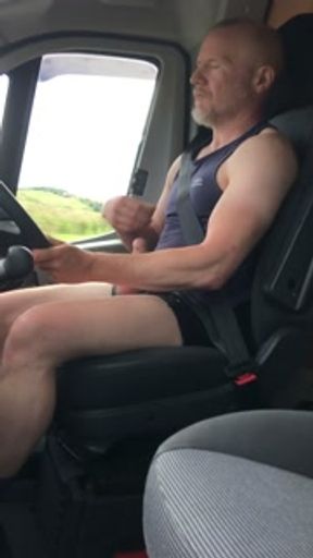 Muscular Daddy truck driver flexes and jerks off while driving