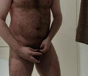 Hairy bear locks his cock in chastity