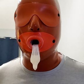 Sissy with Latex Hood Swallows Cum from Condom