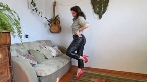 one shoe hopping in leather pants aV