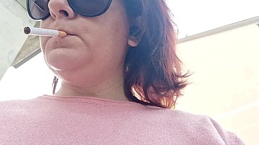 Sexy Italian in the public garden smokes and shows you her big breasts