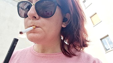 Sexy Italian in the public garden smokes and shows you her big breasts