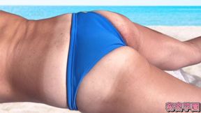 Crossdressing teen plays with huge dick in swimsuit on the beach