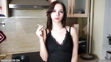 Cigarette smoke wraps tight around a girl’s pink lips