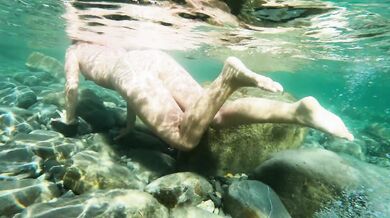 Naked girl dives in the ocean and shows her