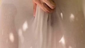 a boy has fun watering his friend s white t-shirt and exposing his smooth ass and big uncut cock