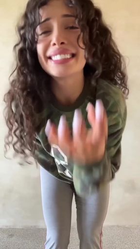Smiling woman in camo sweatshirt