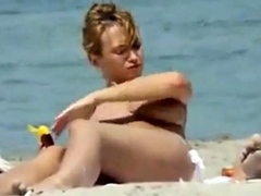 Oiling boobs on topless beach
