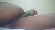 African girl likes to slide a cucumber into her pussy because that's what she enjoys