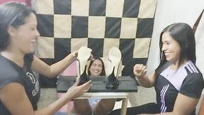 "Francia and Ninoska Tickle Ania in the Stocks"