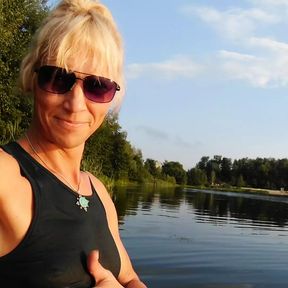 Swimming in the lake in sport wear at sunset.. Wet leggings and t-shirt...