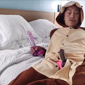 Sucking giant dildo while wearing onesie and pink swimsuit