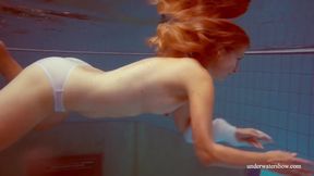 ”In the indoor pool, a mesmerizing babe swims”